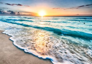 Beach in cancun with ocean and sunrise