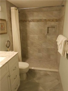 Bathroom with tiled shower and floor