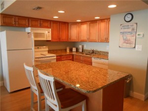 Kitchen with granite countertops, refrigerator, oven, microwave, sink and dishwasher